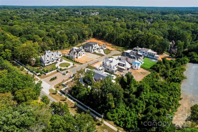 an aerial view of a residential houses with yard