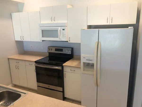 a kitchen with a stove and a refrigerator