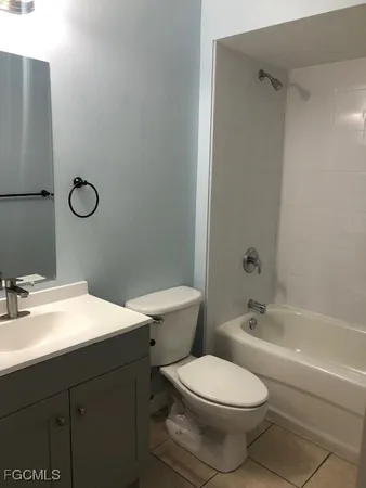 a bathroom with a toilet sink vanity tub and shower