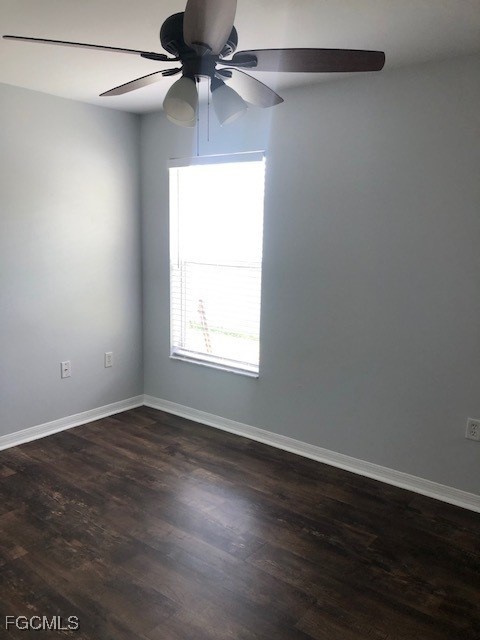 4122 Southwest 7th Place Cape Coral, FL 33914 - Photo 5 of 9 an empty room with wooden floor fan and windows