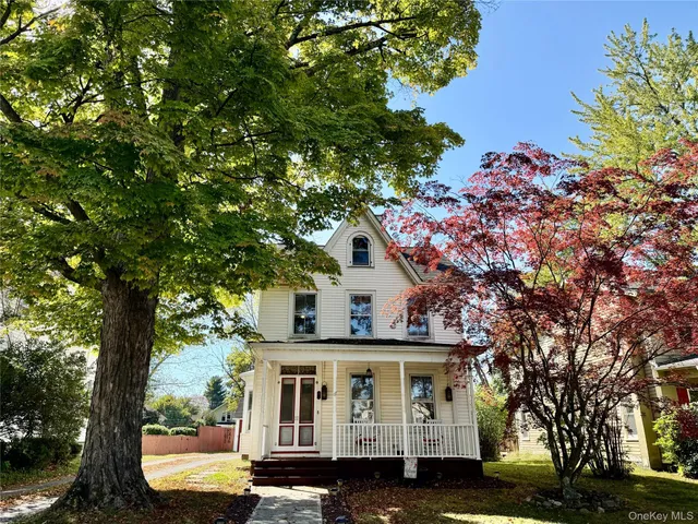 a view of house with a tree in front