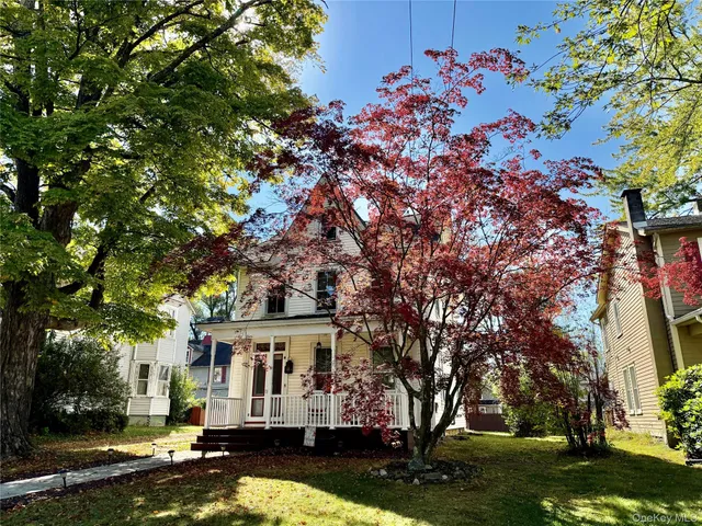 front view of a house with a tree in a yard