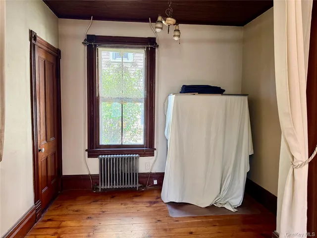 a view of a room with wooden floor and windows