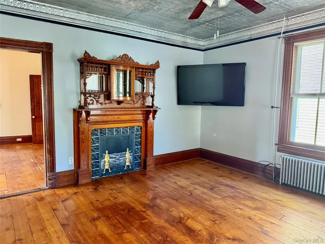 a view of an empty room with a fireplace and a window