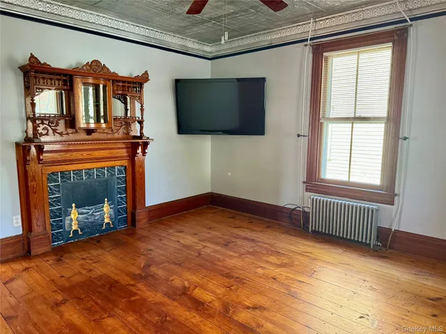 a view of a livingroom with an empty space and a fireplace