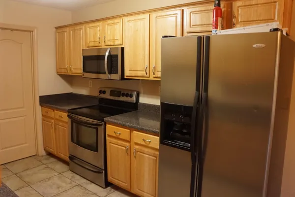 a close view of a refrigerator and a microwave in a kitchen