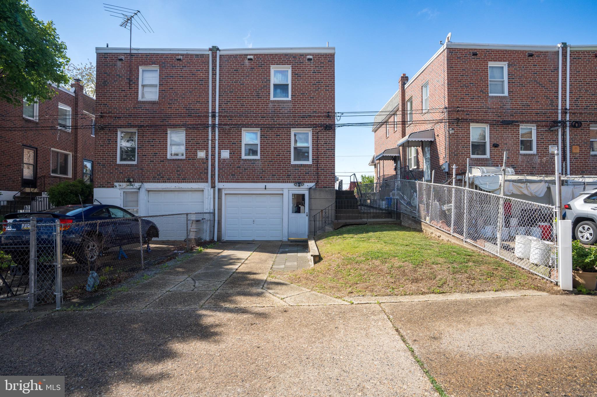 9075 Convent Avenue Philadelphia, PA 19136 - Photo 3 of 17 a view of a brick house with many windows