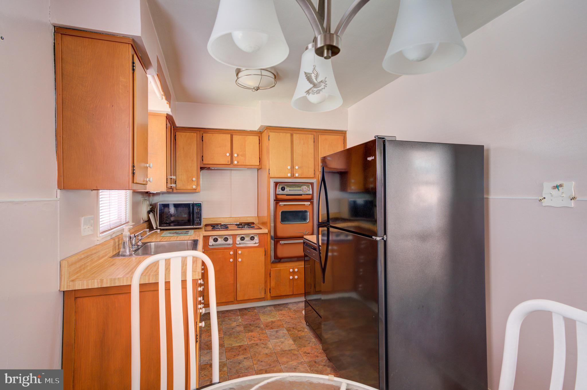 9075 Convent Avenue Philadelphia, PA 19136 - Photo 4 of 17 a kitchen with stainless steel appliances granite countertop a refrigerator a stove top oven a sink and dishwasher