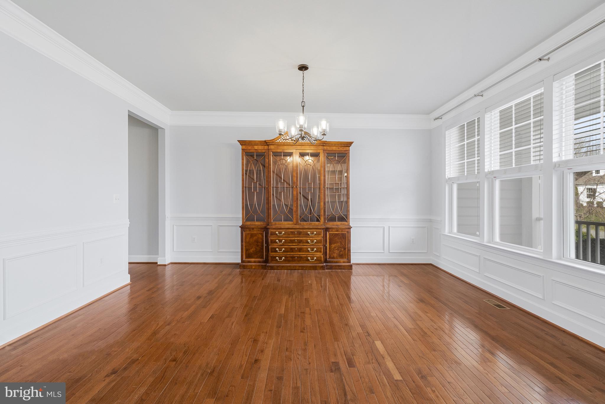41729 Wakehurst Place Leesburg, VA 20176 - Photo 11 of 71 a view of an empty room with a window and wooden floor