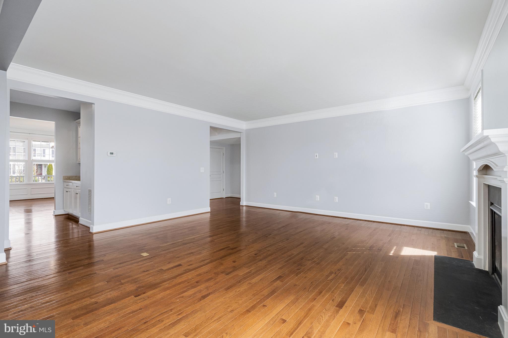 41729 Wakehurst Place Leesburg, VA 20176 - Photo 15 of 71 a view of an empty room with wooden floor and a window