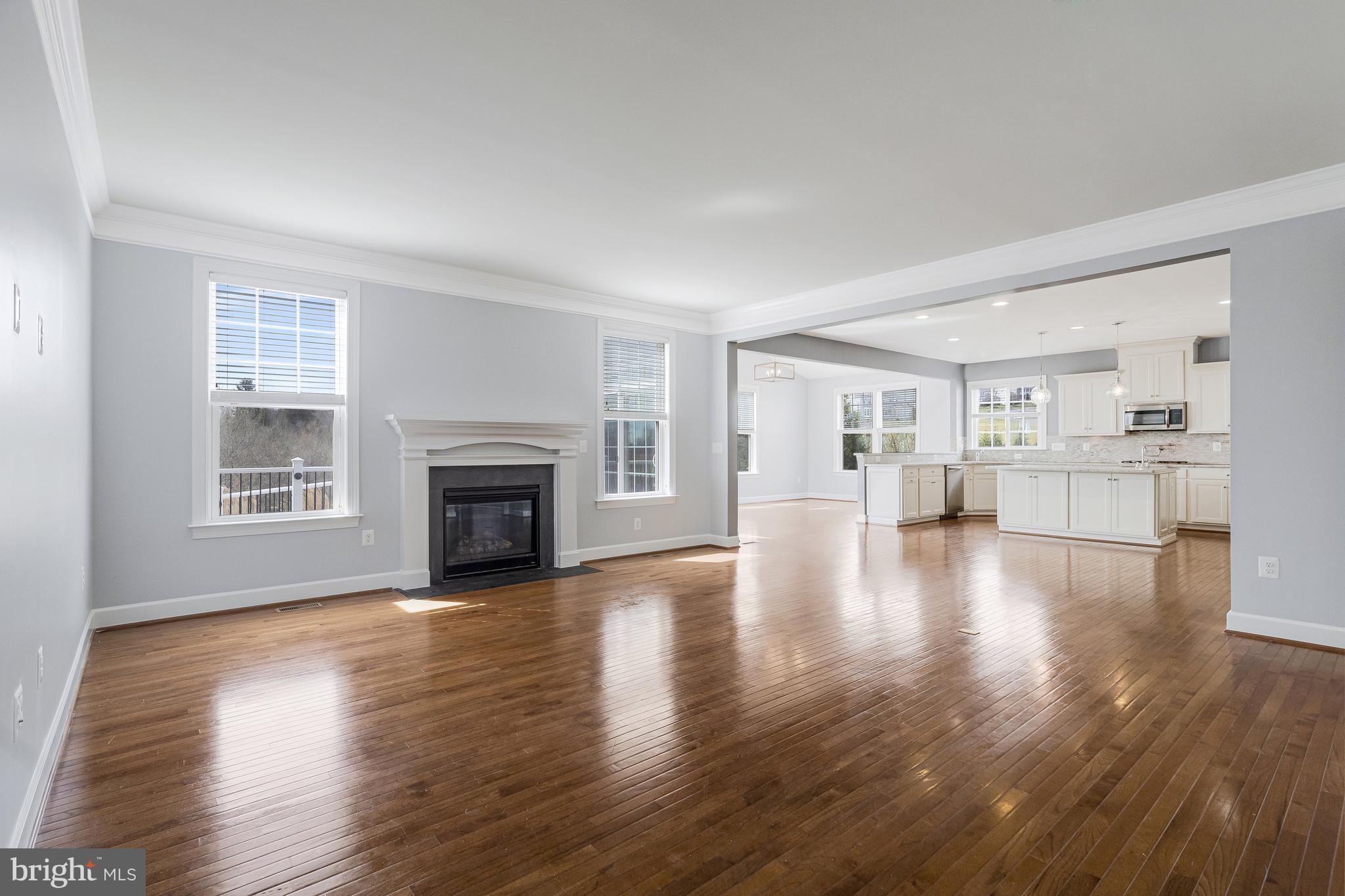 41729 Wakehurst Place Leesburg, VA 20176 - Photo 19 of 71 a view of a livingroom with wooden floor and a kitchen