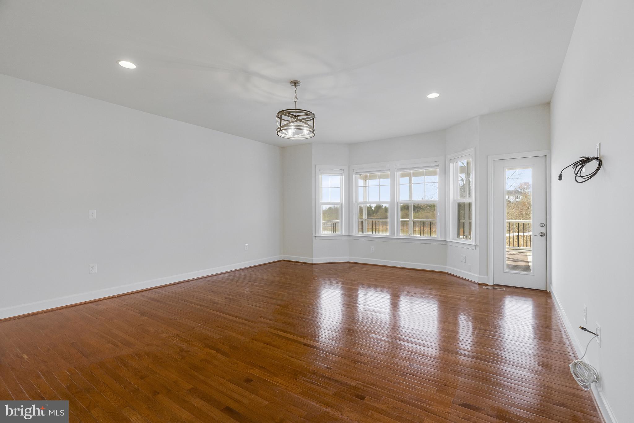 41729 Wakehurst Place Leesburg, VA 20176 - Photo 32 of 71 a view of an empty room with wooden floor and a window