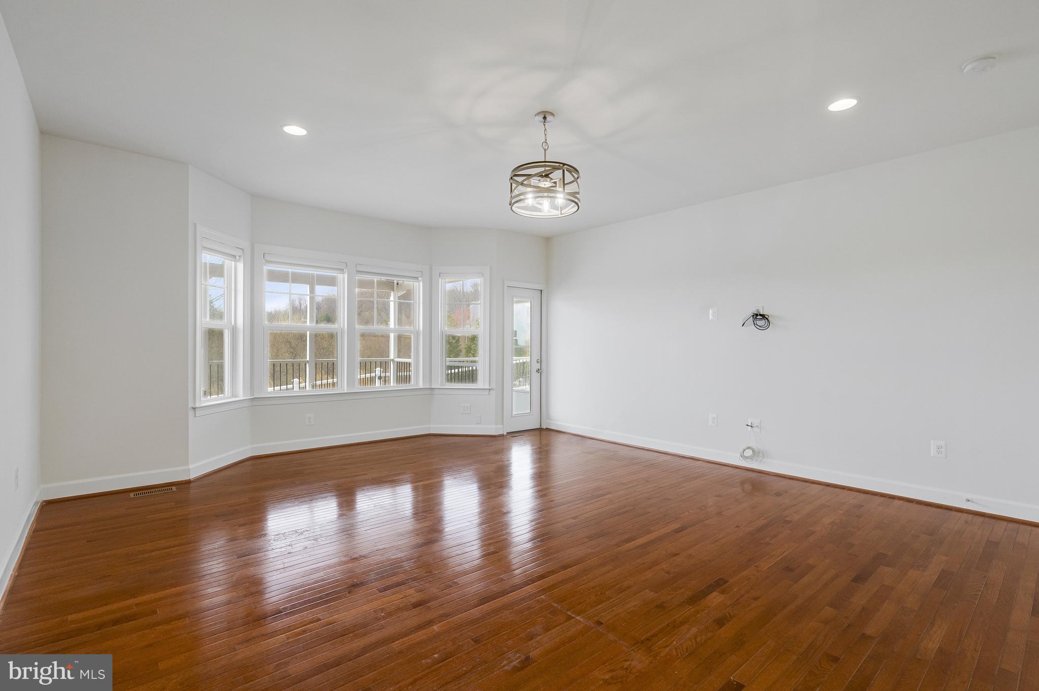 41729 Wakehurst Place Leesburg, VA 20176 - Photo 33 of 71 a view of an empty room with wooden floor and a window