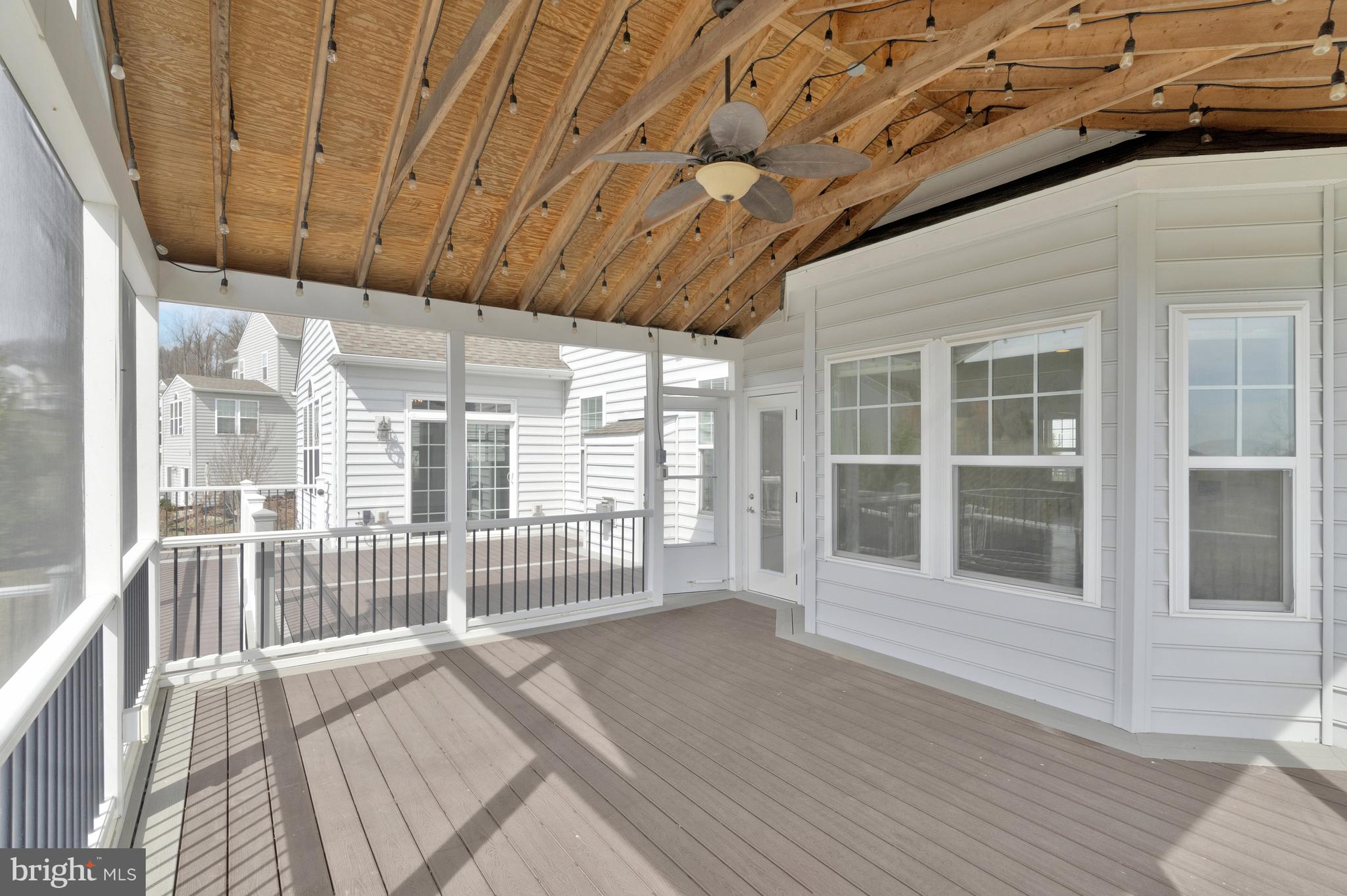 41729 Wakehurst Place Leesburg, VA 20176 - Photo 35 of 71 a view of a porch with wooden floor and iron fence