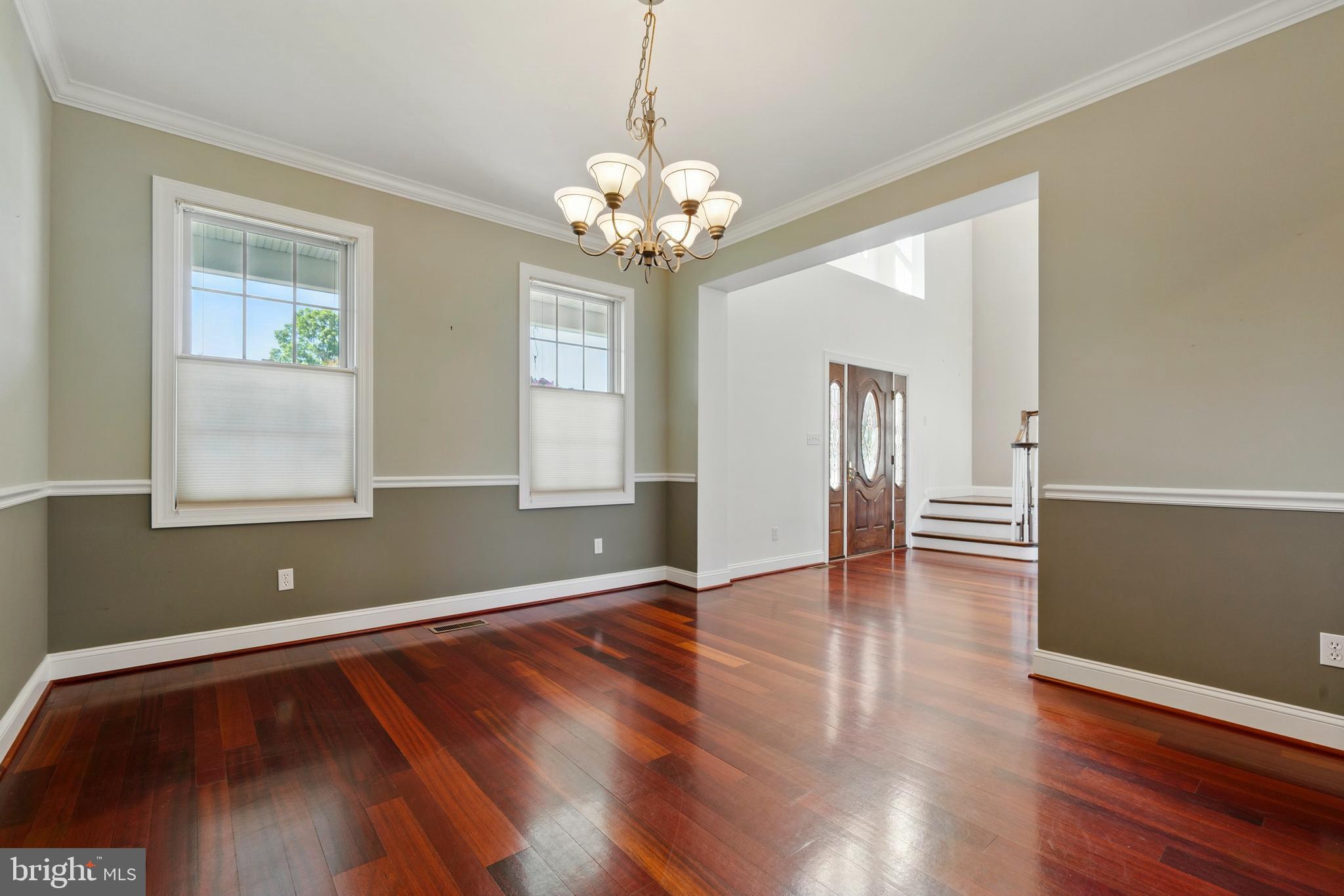 6119 New Street, Unit 2 Rock Hall, MD 21661 - Photo 10 of 44 a view of an empty room with wooden floor and a window