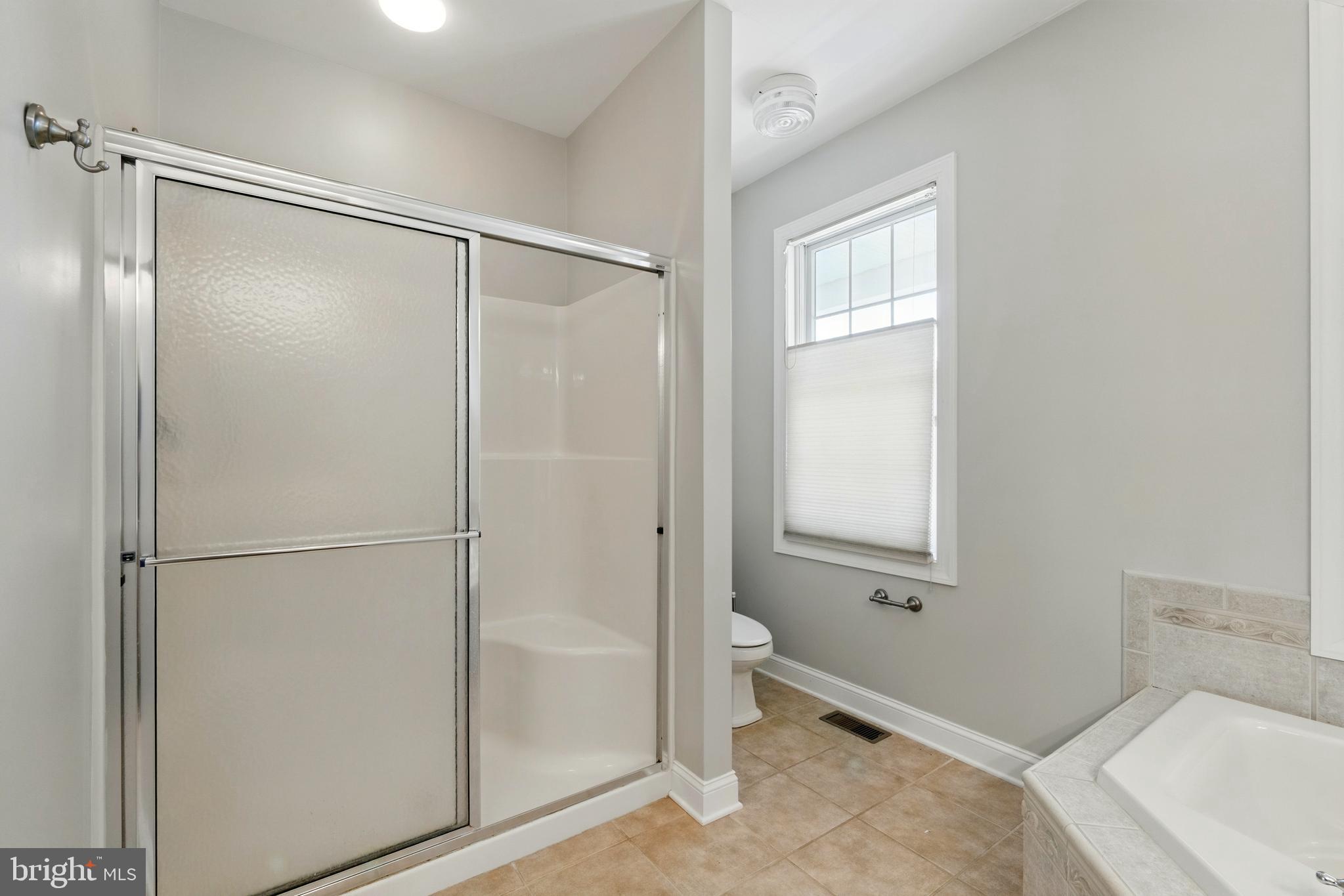 6119 New Street, Unit 2 Rock Hall, MD 21661 - Photo 17 of 44 a bathroom with a bathtub and a shower