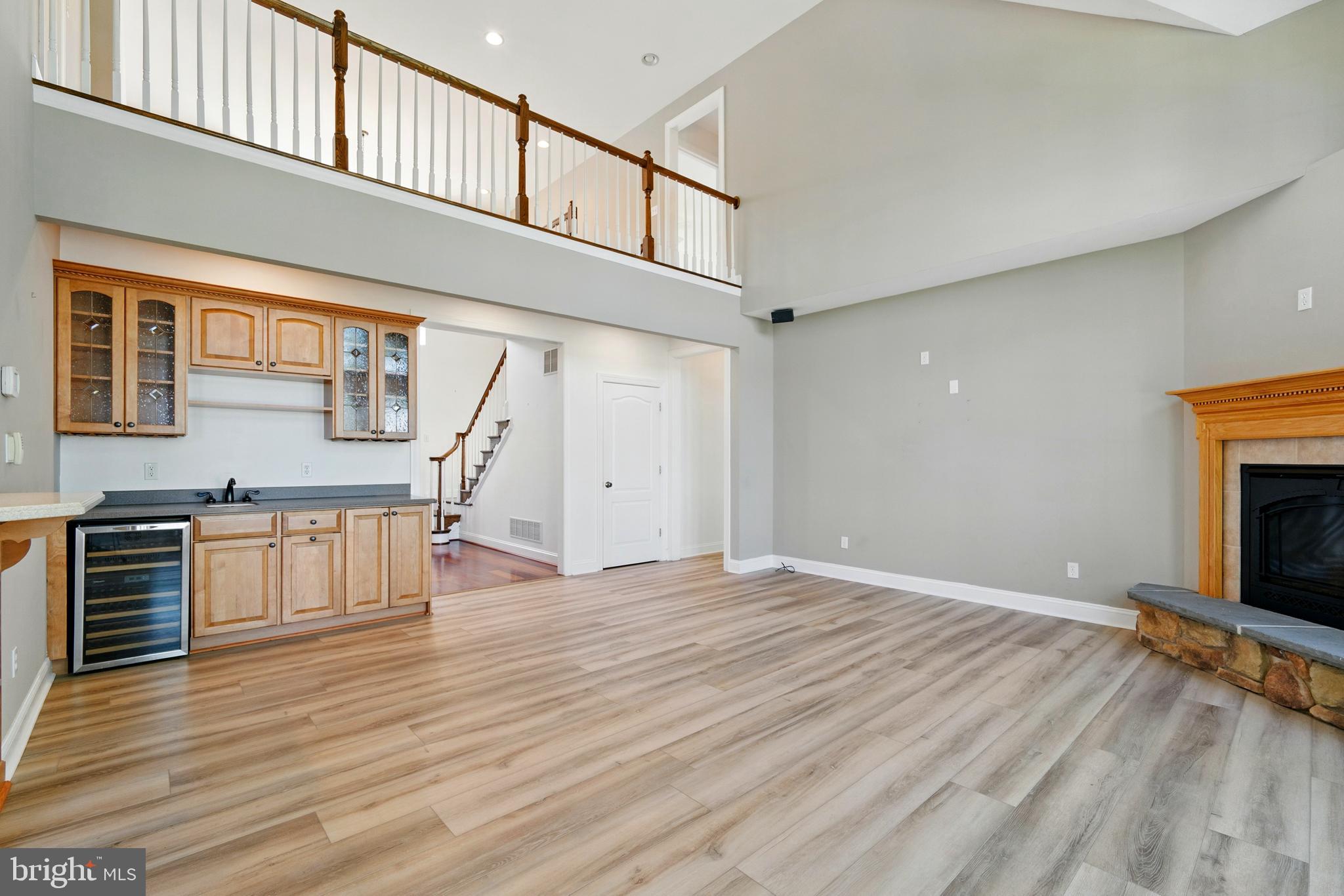6119 New Street, Unit 2 Rock Hall, MD 21661 - Photo 5 of 44 wooden floor in an empty room with a fireplace and a window