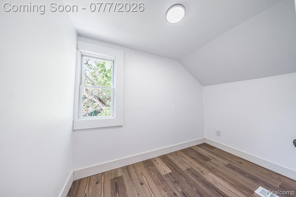 18486 Trinity Street Detroit, MI 48219 - Photo 14 of 19 Room featuring wood-finish flooring, white walls, and a recessed ceiling light