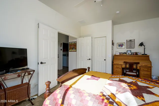 a bedroom with furniture and a flat screen tv
