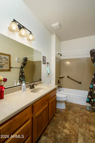 a bathroom with a sink a large mirror and a bathtub