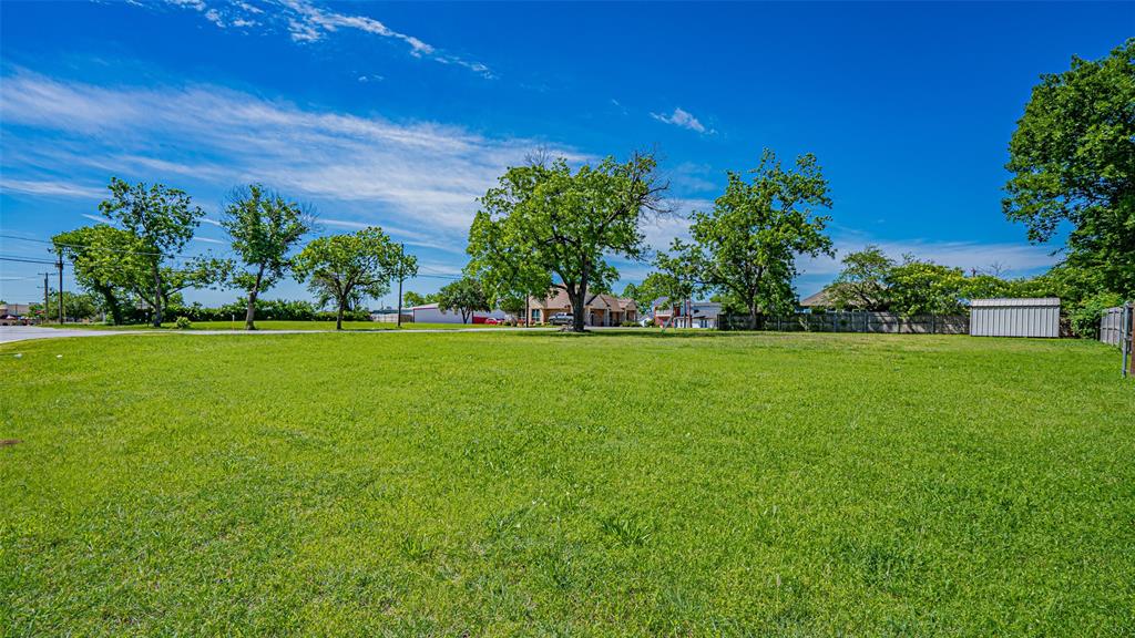 124 Southwest Anderson Street Burleson, TX 76028 - Photo 21 of 36 a view of a field of grass and trees