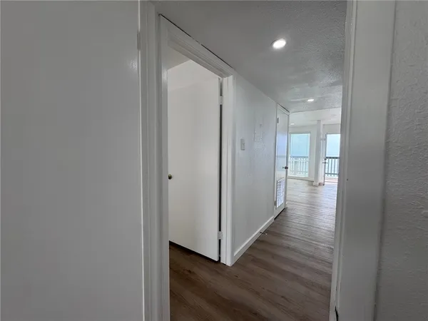 a bathroom with a bathtub shower sink vanity mirror and toilet