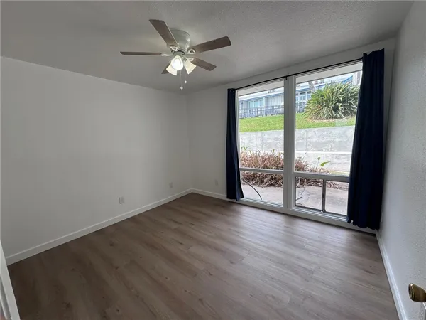 an empty room with an entrance and a fireplace