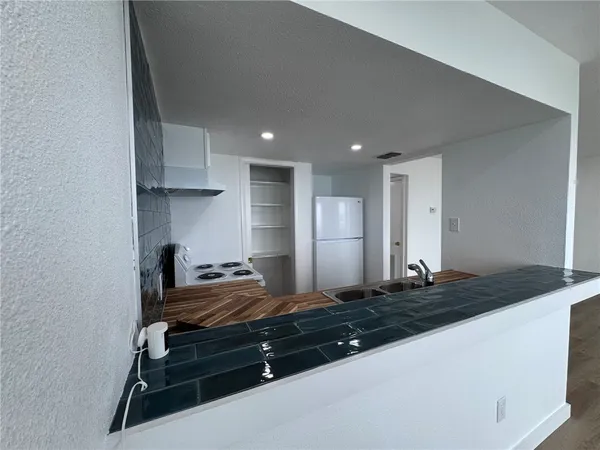 a kitchen with a sink stove and cabinets