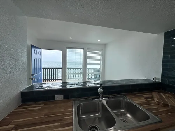 a kitchen with a stove sink and refrigerator