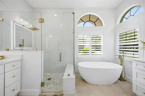 a spacious bathroom with a bathtub and a sink