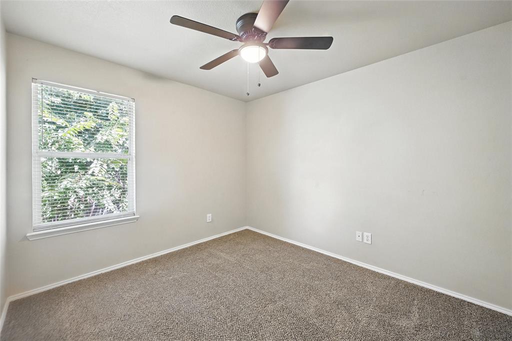 1321 Village Garden Azle, TX 76020 - Photo 11 of 20 an empty room with a window and a fan