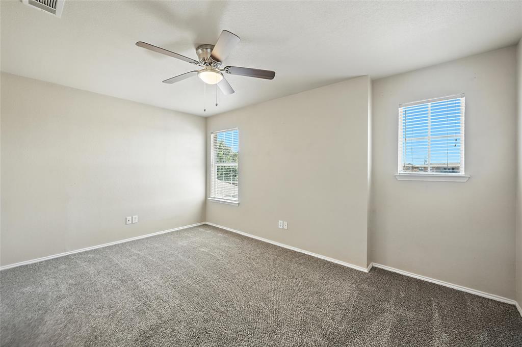 1321 Village Garden Azle, TX 76020 - Photo 13 of 20 an empty room with windows and fan