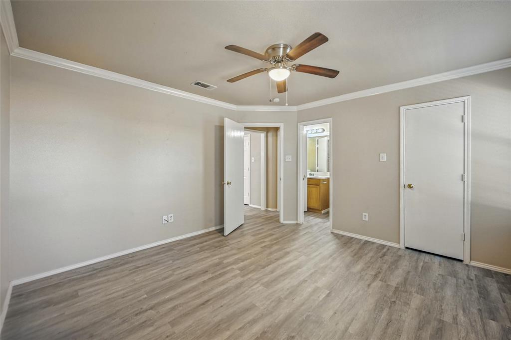 1321 Village Garden Azle, TX 76020 - Photo 15 of 20 a view of an empty room with wooden floor and a ceiling fan