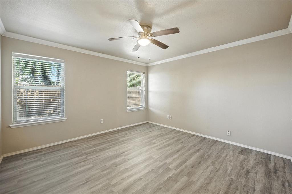 1321 Village Garden Azle, TX 76020 - Photo 16 of 20 a view of an empty room with wooden floor and a window