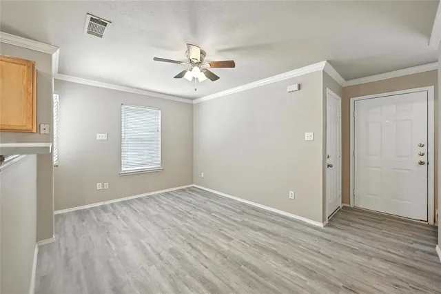 a view of room with window ceiling fan and hardwood floor