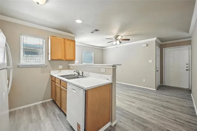 a view of a kitchen cabinets a sink and wooden floor