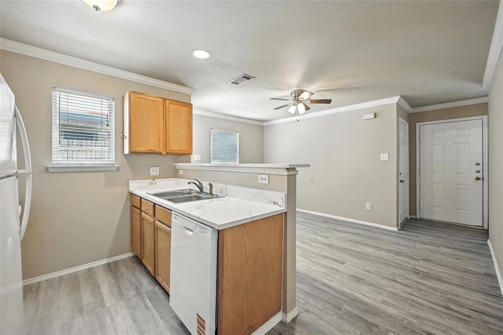 1321 Village Garden Azle, TX 76020 - Photo 7 of 20 a view of a kitchen cabinets a sink and wooden floor