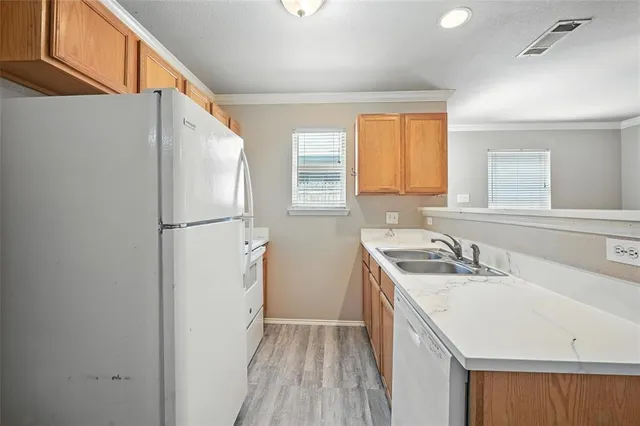 a kitchen with a sink a refrigerator a washer and dryer