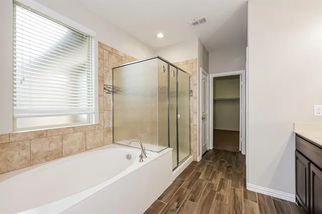 a bathroom with a bathtub and a shower