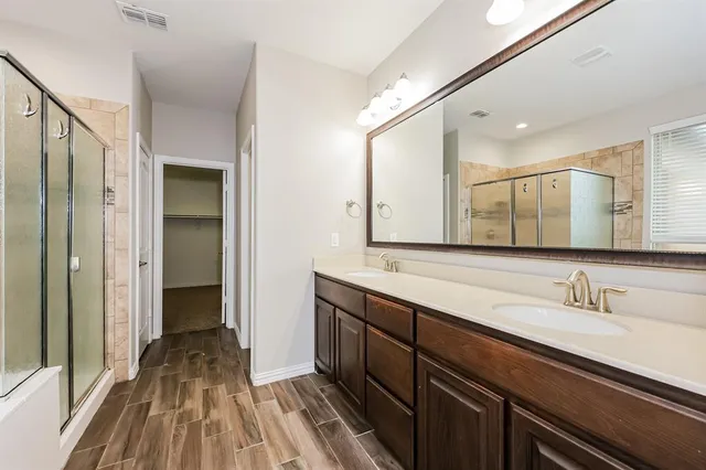 a spacious bathroom with a double vanity sink and a mirror