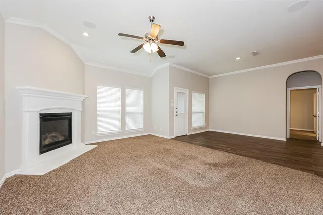 a view of empty room with wooden floor and fireplace