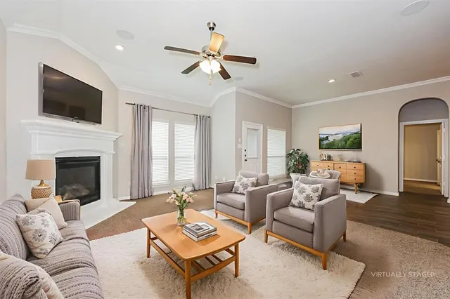 a living room with furniture fireplace and flat screen tv