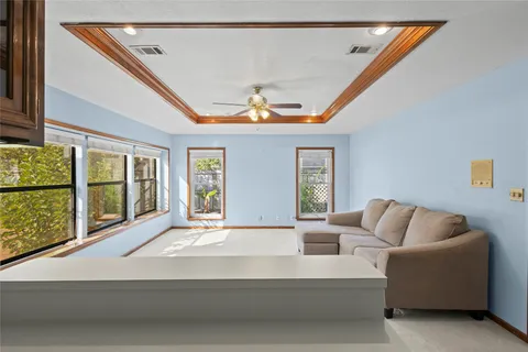 a living room with furniture and large windows