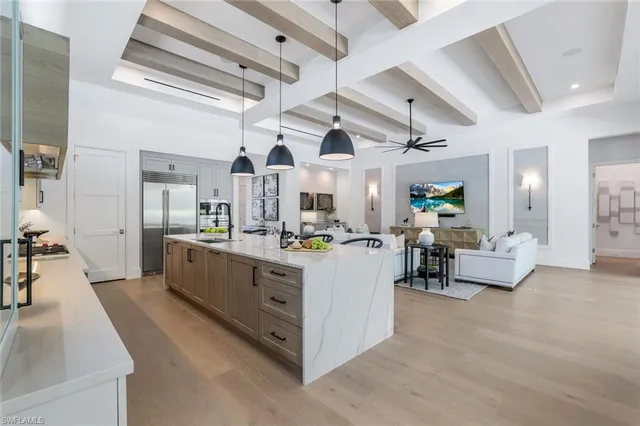 a large white room with lots of wooden furniture