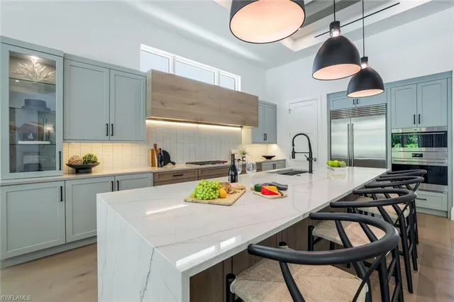 a view of a dining room with furniture and chandelier