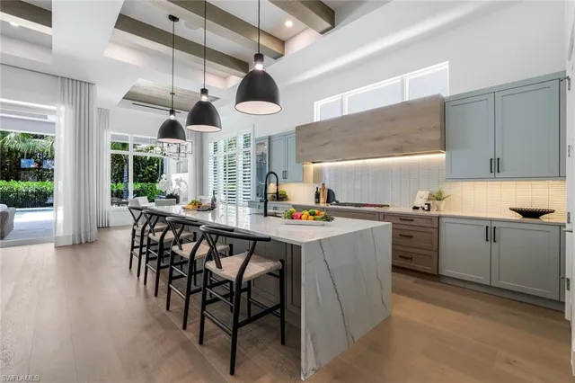 a kitchen with a table chairs stove and cabinets
