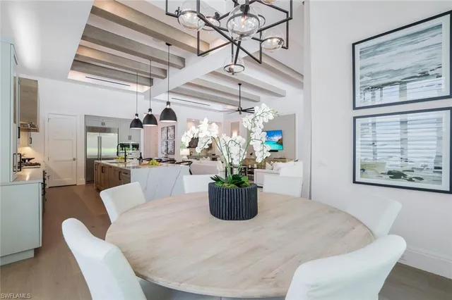 a dining room with furniture and a potted plant