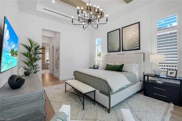 a bedroom with a bed potted plant with the outer view