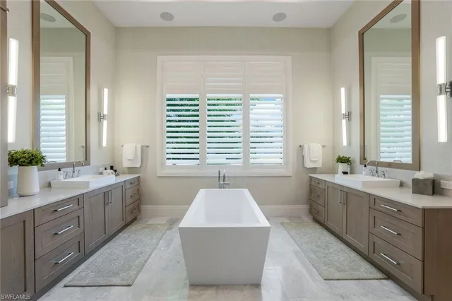 a bathroom with a tub sink and mirror