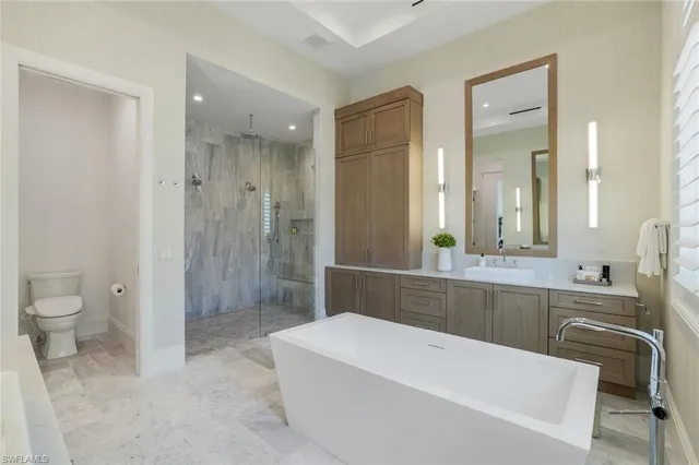 a bathroom with a bathtub a toilet a sink and shower